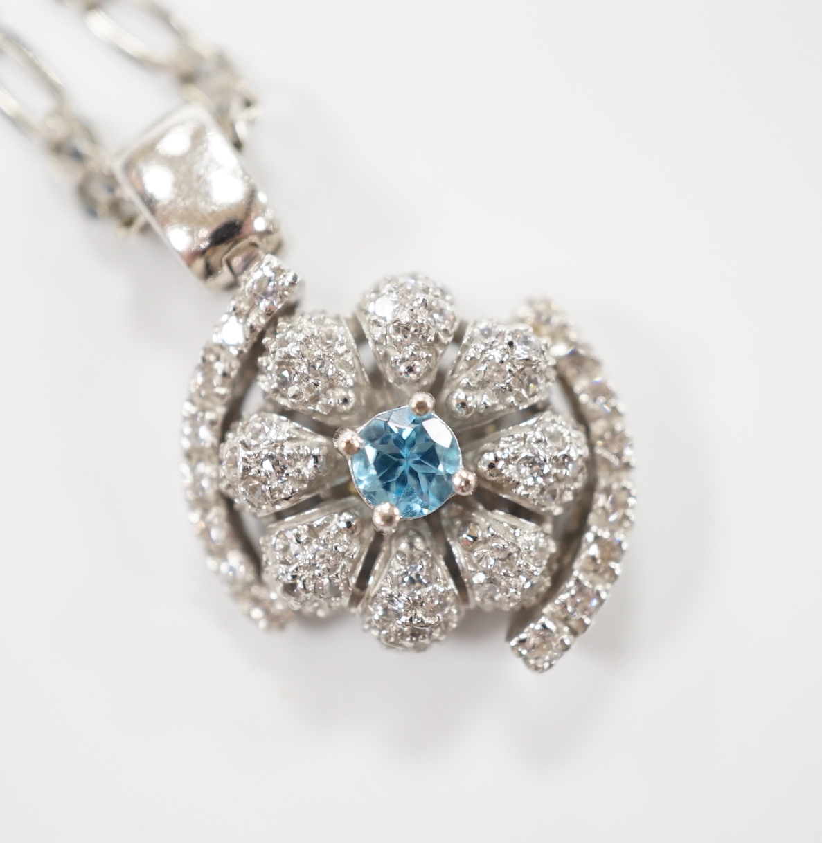 A modern 14ct gold, topaz? and simulated diamond chip cluster set pendant, 20mm, on a 9ct chain, 44cm, gross weight 11.2 grams